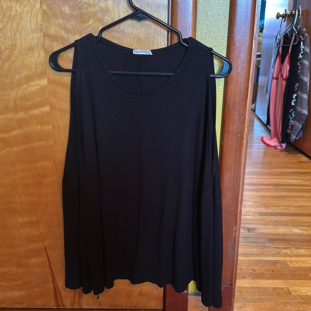 A black long sleeved shirt with circle cutouts on the shoulders